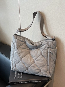 Grey quilted puffer tote bag with diamond stitching and adjustable shoulder strap