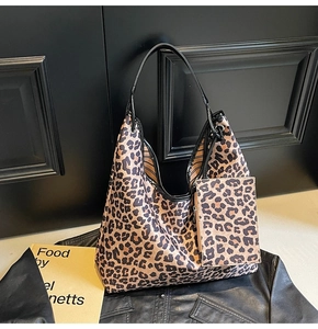 Detail of hobo shoulder bag with leopard print, leather handles and mini matching pouch