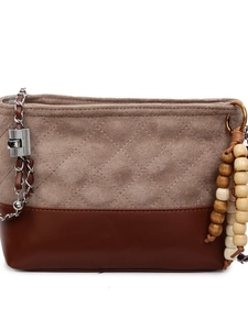 Brown quilted crossbody bucket bag with chain strap and colorful wooden bead charm