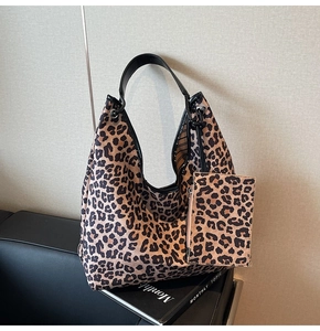 Detail of leopard print tote bag with a matching small hanging zipper pouch accessory