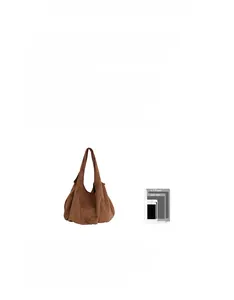 Size comparison of brown suede tote bag with an iPad showing its spacious capacity