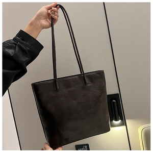 Detail of large brown tote bag with vintage cracked texture leather and dual shoulder straps