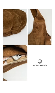 Detail view of large brown suede tote bag showing soft texture and spacious inner pocket