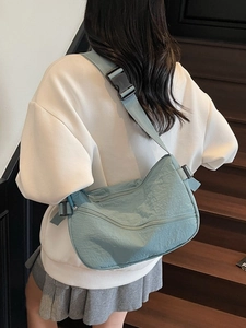 Light blue nylon crossbody sling bag for women with adjustable strap and casual style