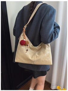 Beige matte PU leather hobo bag with vintage texture and plush pompom charm detail