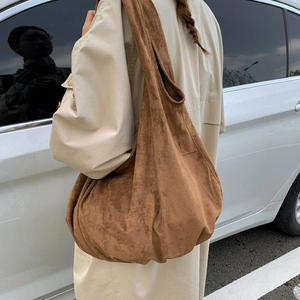 Close-up of the vintage brown suede large tote bag featuring soft pleated texture and strap