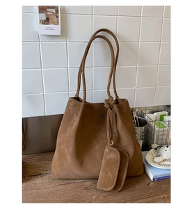 Detailed macro of brown suede tote bag with COIN 2DN logo and small inner pouch