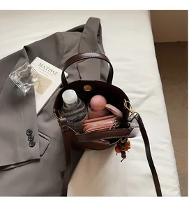 Interior view of the brown suede bucket bag showing spacious capacity for daily essentials