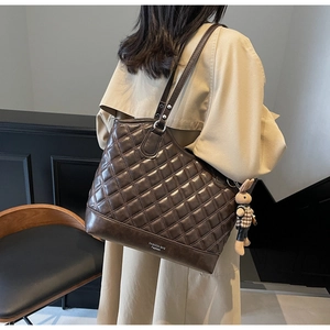 Quilted dark brown bucket bag with diamond stitching and cute rabbit charm detail
