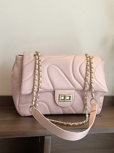 Quilted light pink crossbody bag with wavy stitching and golden chain strap for women