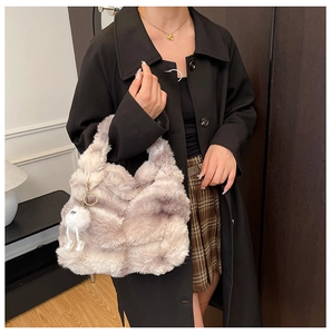 Detail of plush tote bag in purple and white gradient with fluffy charm and soft handle