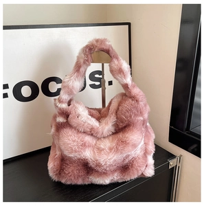 Detail of soft pink faux fur tote bag showing fluffy texture on minimalist metal stand