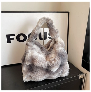 Detail of faux fur handbag showing grey and white gradient fluffy plush texture