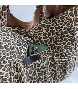 Close-up of front pocket on leopard canvas tote bag for easy phone storage