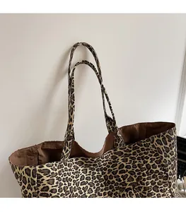 Close-up of leopard print tote bag with durable canvas straps and brown lining
