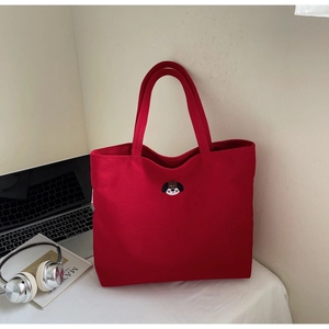 Detailed view of red canvas tote bag with exquisite puppy embroidery for daily use