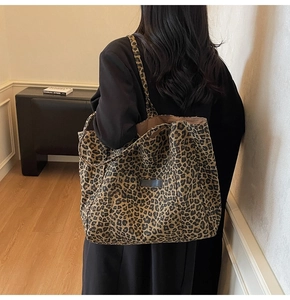 Detail shot of the large leopard print tote bag fabric and long shoulder strap
