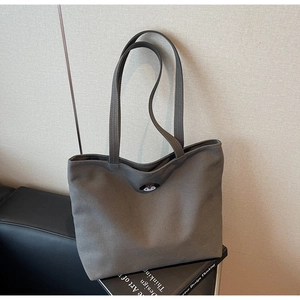 Close-up of cute bear embroidery on dark gray canvas tote bag with dual long handles
