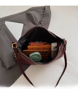 Interior view of the burgundy shoulder bag showing high capacity for daily essentials