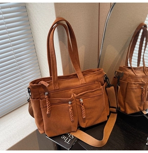 Detail view of caramel corduroy tote bag showing woven zipper pulls and textured fabric