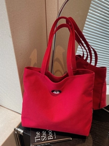 Red canvas tote bag with cartoon dog embroidery shown in a modern lifestyle mirror setting