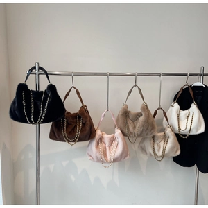 Close-up of fuzzy plush handbags in six colors with gold chain straps and soft texture