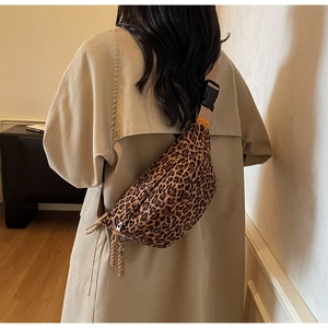 Detail of adjustable strap and plastic buckle on leopard print crossbody chest bag