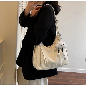 Creamy white oversized faux leather tote bag with silver zipper and cloud charm detail