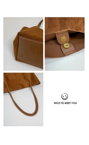 Detail of brown suede tote bag with magnetic clasp and reinforced bottom panel