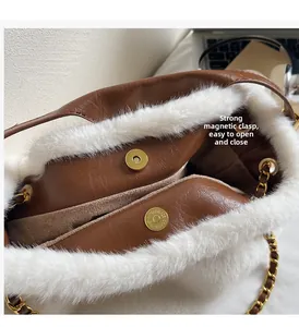 Detail of the strong magnetic buckle closure on a plush brown faux leather tote bag