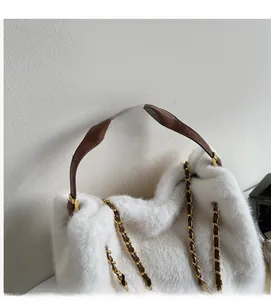 Close-up of white faux fur handbag featuring brown leather strap and gold chain detail