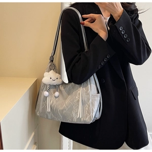 Detail of silver pleated tote bag featuring decorative zippers and a plush cloud charm