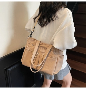 Detailed view of camel corduroy tote bag with dual front zipper pockets and adjustable straps