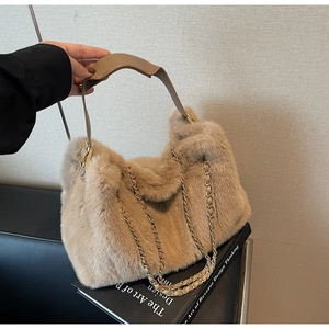 Detail of plush camel faux fur handbag with premium leather handle and gold chain strap