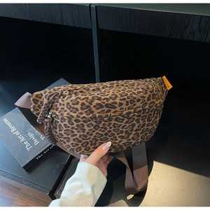 Detail of leopard print waist bag featuring orange brand label and woven zipper pull cord