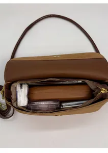 Interior view of brown leather crossbody bag showing spacious daily storage capacity
