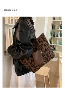 Detail view of large leopard print tote bag with brown straps and matching small zip pouch