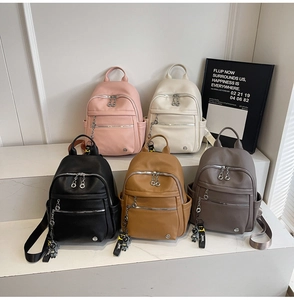 Litchi pattern PU leather backpacks in five colors with cute astronaut pendant detail