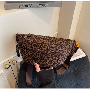 Detail of leopard print waist bag featuring adjustable brown strap and orange brand label