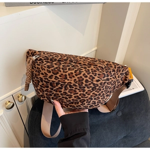 Detail view of leopard print canvas waist bag with adjustable strap and braided zipper pull