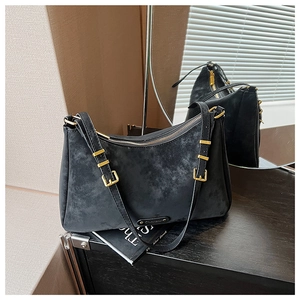 Detail view of black frosted matte leather hobo bag with vintage texture and gold hardware