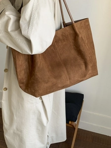 Large caramel suede tote bag for women shown with an elegant beige trench coat
