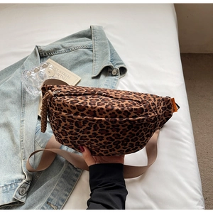 Detailed close-up of leopard print crossbody bag with orange label and nylon strap