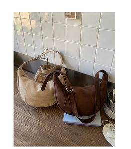Detail of adjustable strap and soft matte suede hobo bags in beige and dark brown