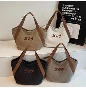Detailed display of four color options for minimalist canvas tote bags with XQG embroidery