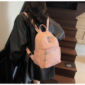 Pink lychee texture backpack with metallic ring zippers and dual front compartments