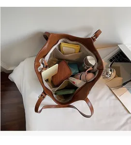 Internal view of brown tote bag showing large capacity and multi-functional inner pockets