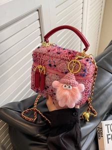 Pink tweed mini bucket bag with leather handle, chain strap and furry monster charm