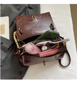Interior view of brown faux leather crossbody bag showing spacious storage for daily items