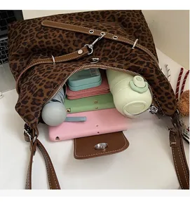 Interior view showing the large capacity and multiple compartments of leopard print tote